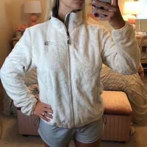 White fuzzy north face jacket
